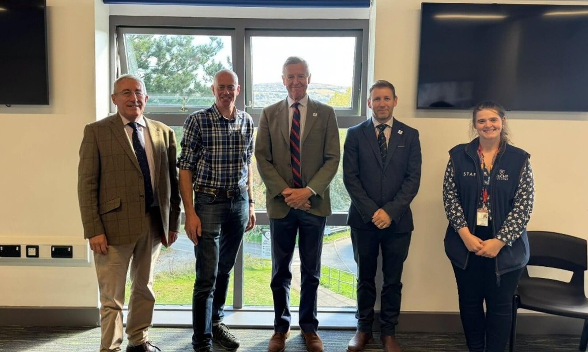 Five people standing in a classroom at Duchy College Stoke Climsland