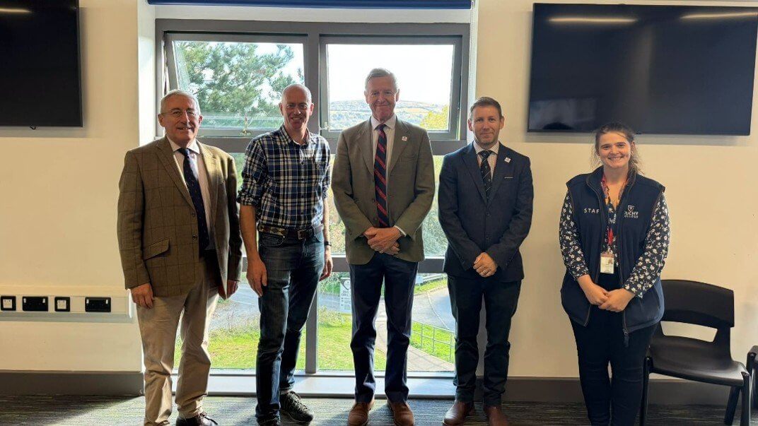 Five people standing in a classroom at Duchy College Stoke Climsland