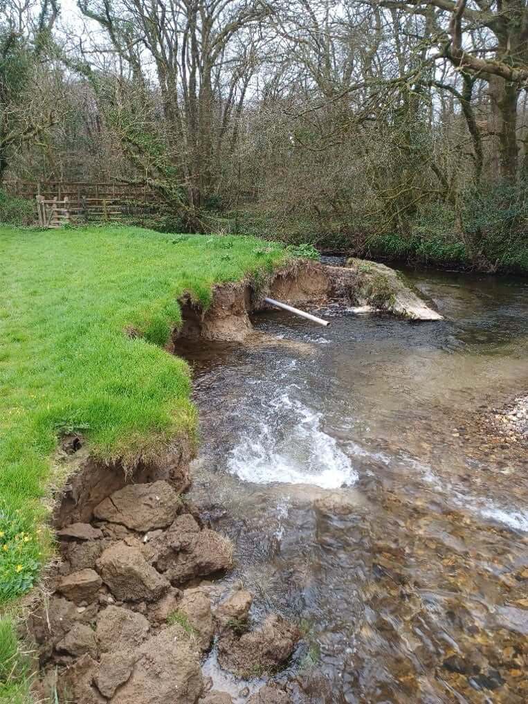 Eroded riverbank collapsing into the Lower River Ruthern before the repair