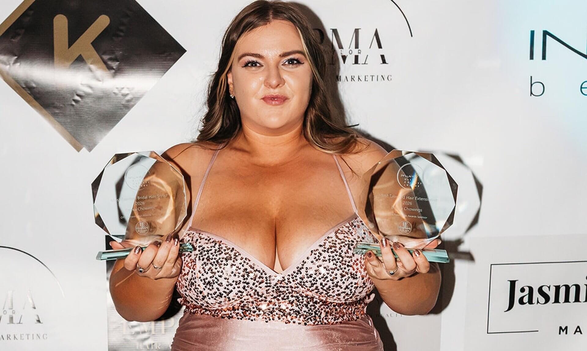 Emma Chowings holding two glass trophies at the Cornwall Hair and Beauty Awards 2026