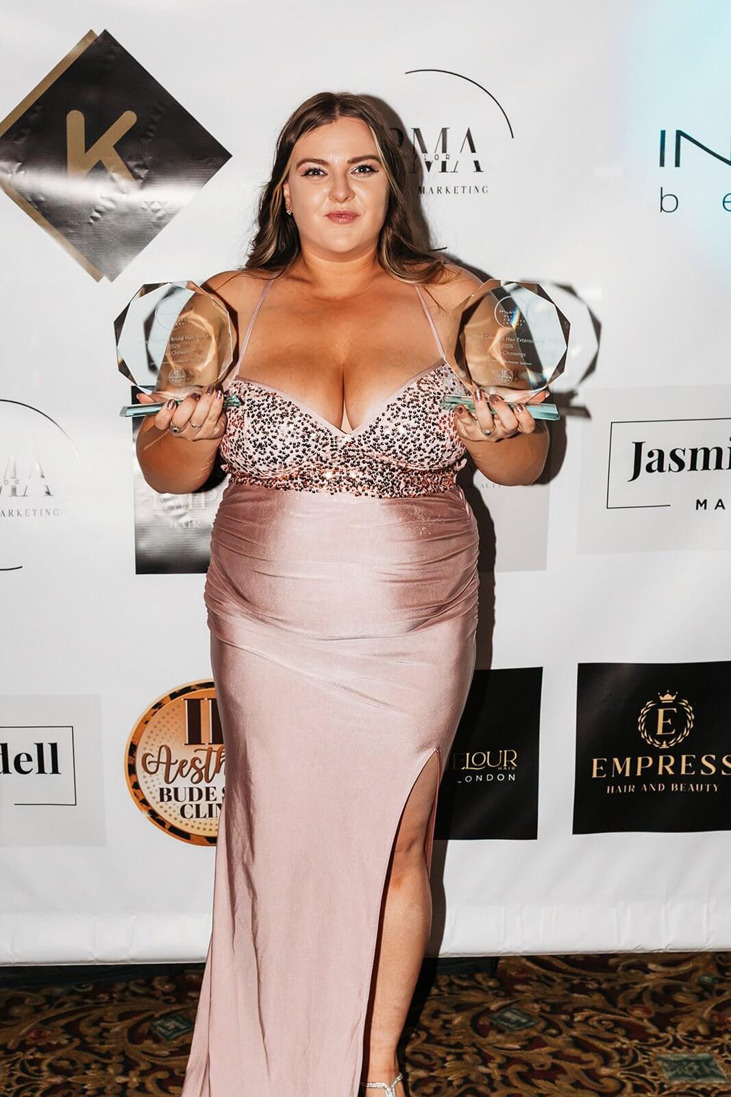 Emma Chowings holding two glass trophies at the Cornwall Hair and Beauty Awards 2026