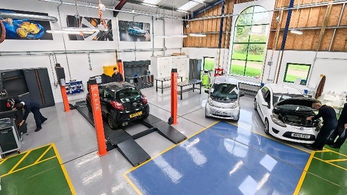 Students working on cars inside the new Engineering Skills Centre workshop