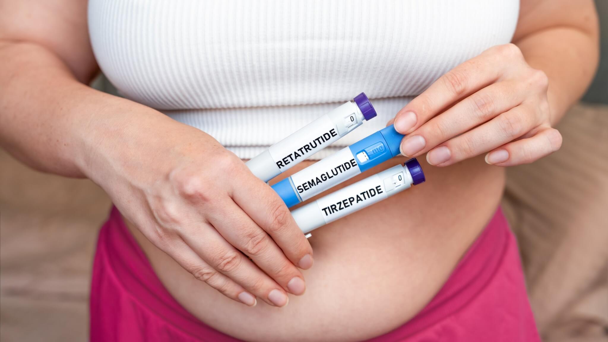 Woman holding weight loss injection pens