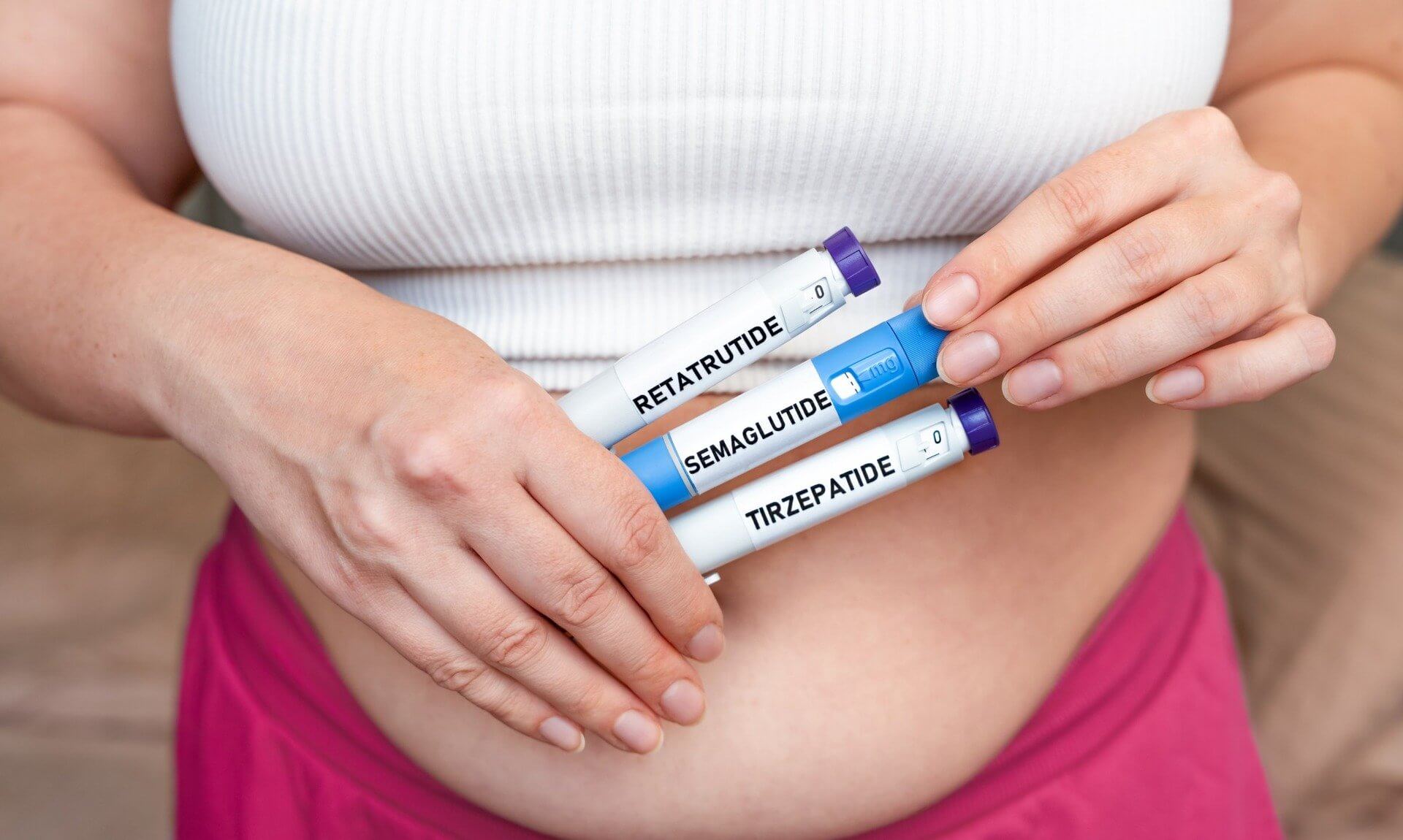 Woman holding weight loss injection pens