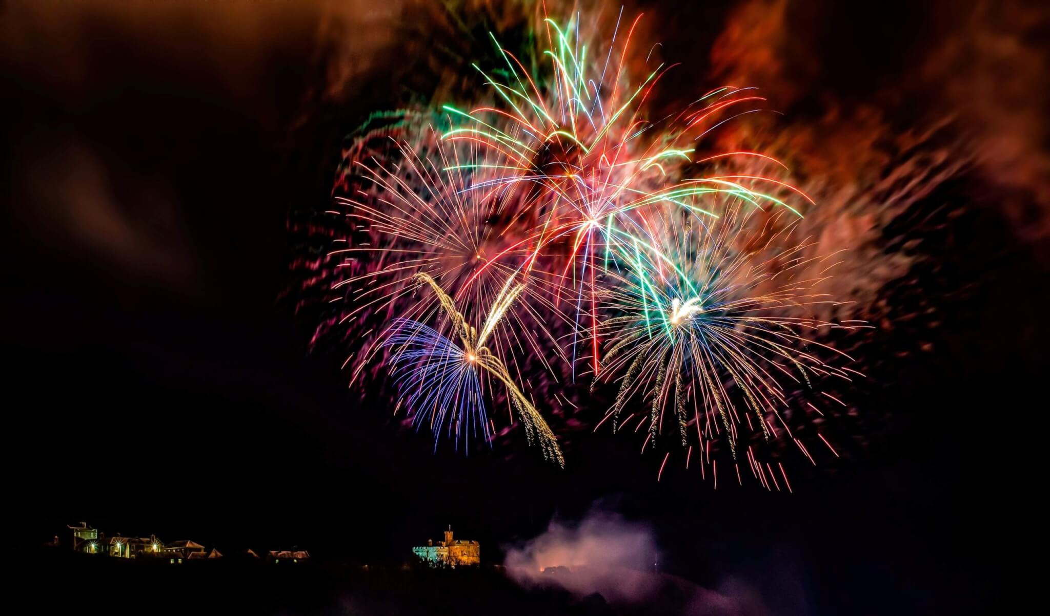 Fireworks bursting over Pendennis Castle in Falmouth at night