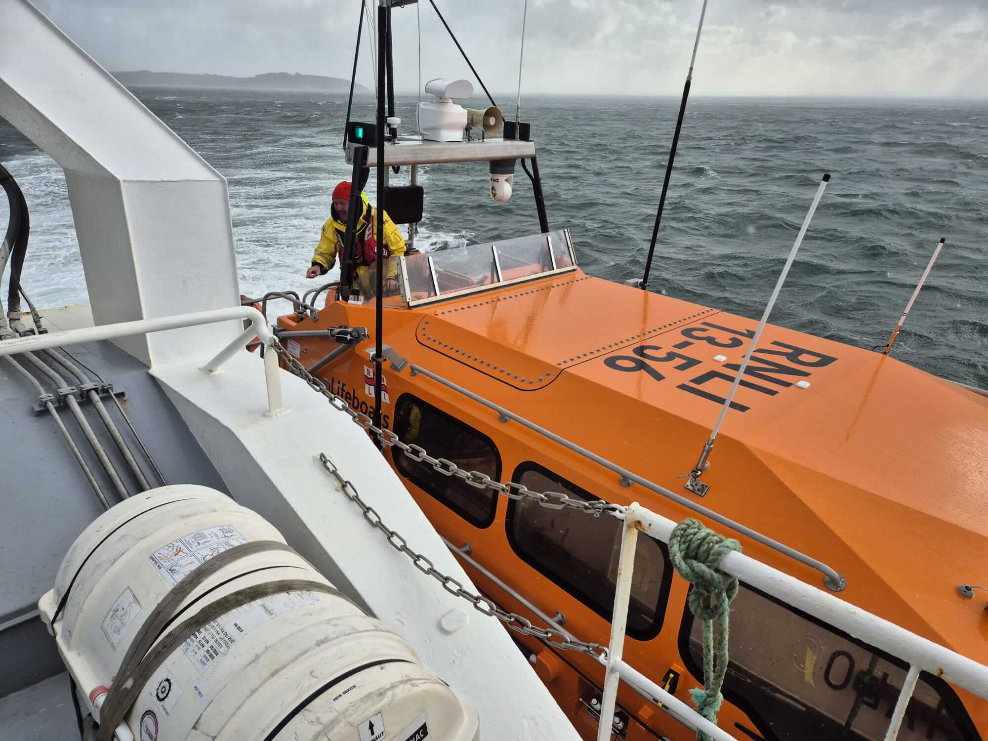 Falmouth RNLI lifeboat Decibel Too alongside a French fishing vessel