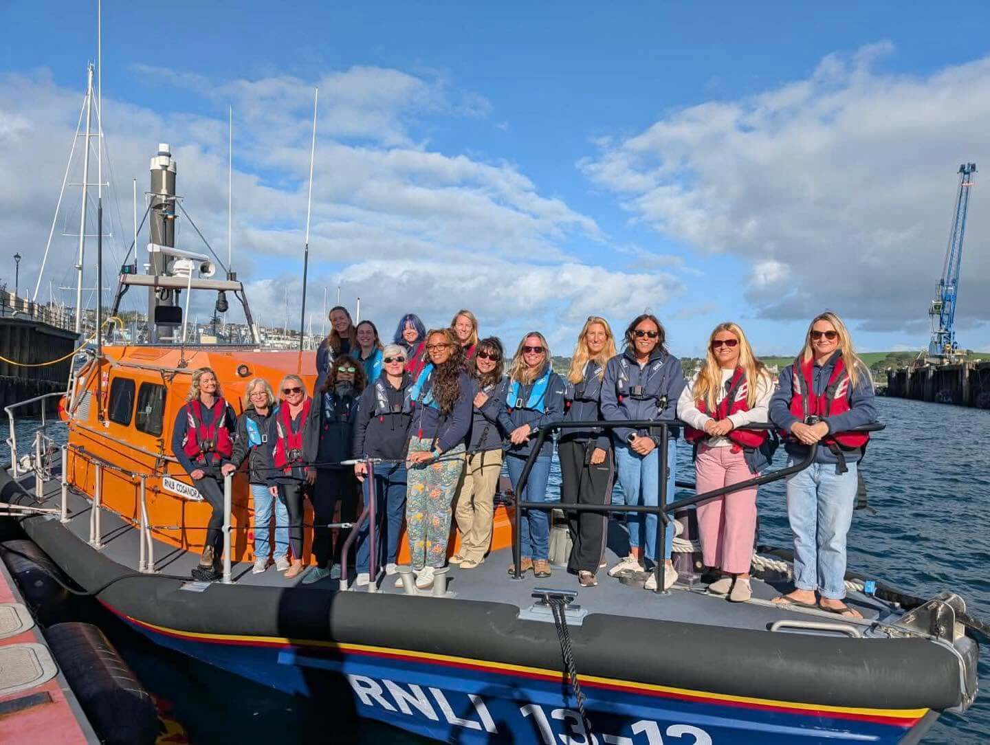 Women from south west lifeboat stations on an RNLI lifeboat in Falmouth harbour