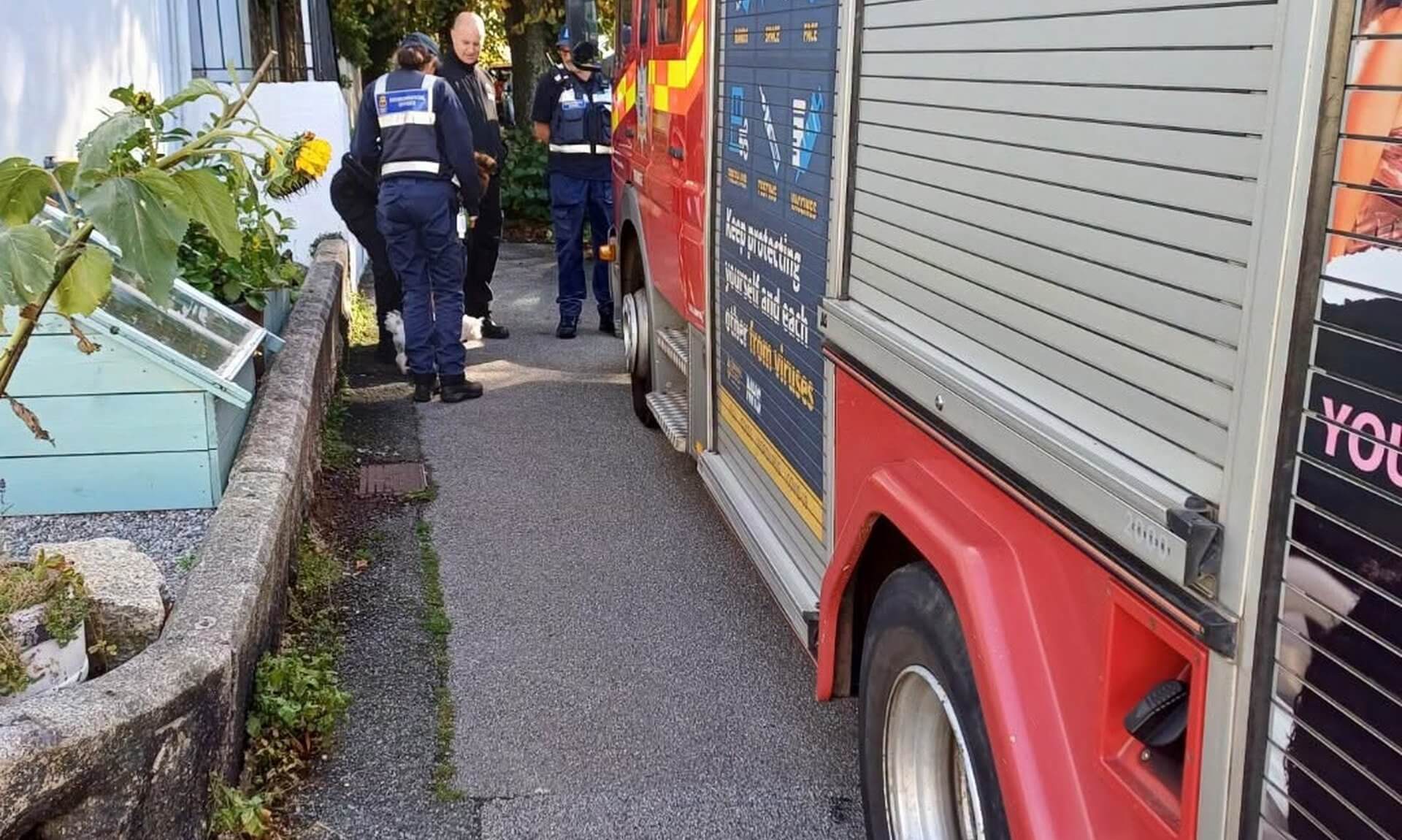 Fire engine parked beside officers on a Falmouth street during the Student Hello Visits