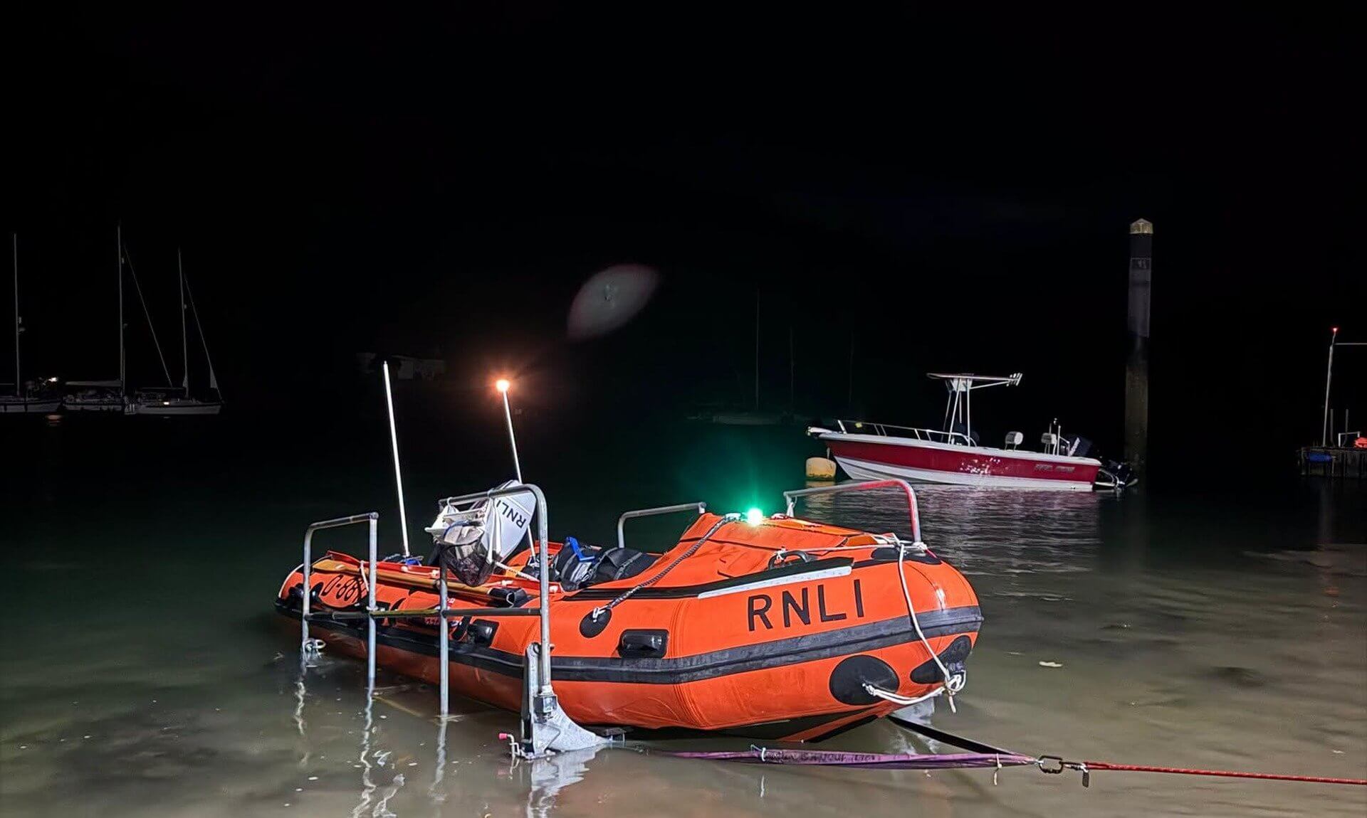 Fowey RNLI inshore lifeboat in the shallows at night