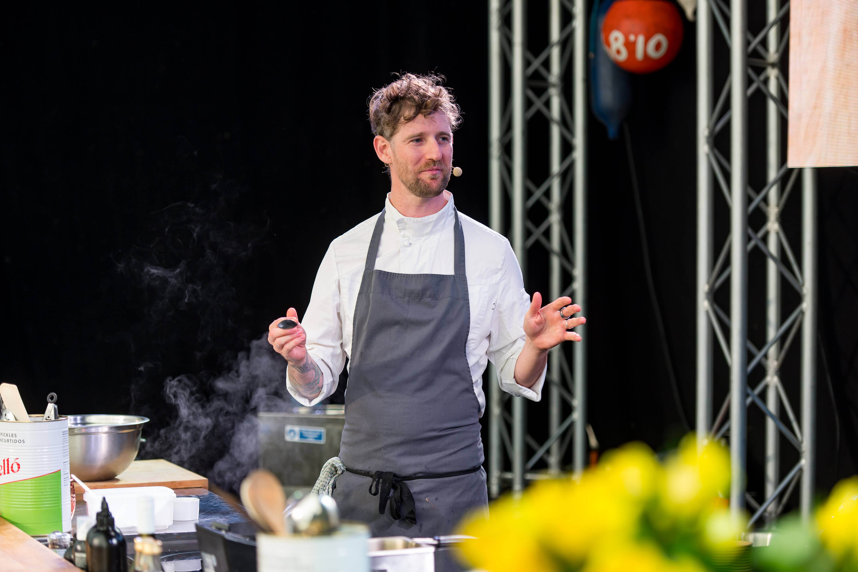 A chef giving a cookery demonstration on stage at Falmouth Oyster Festival
