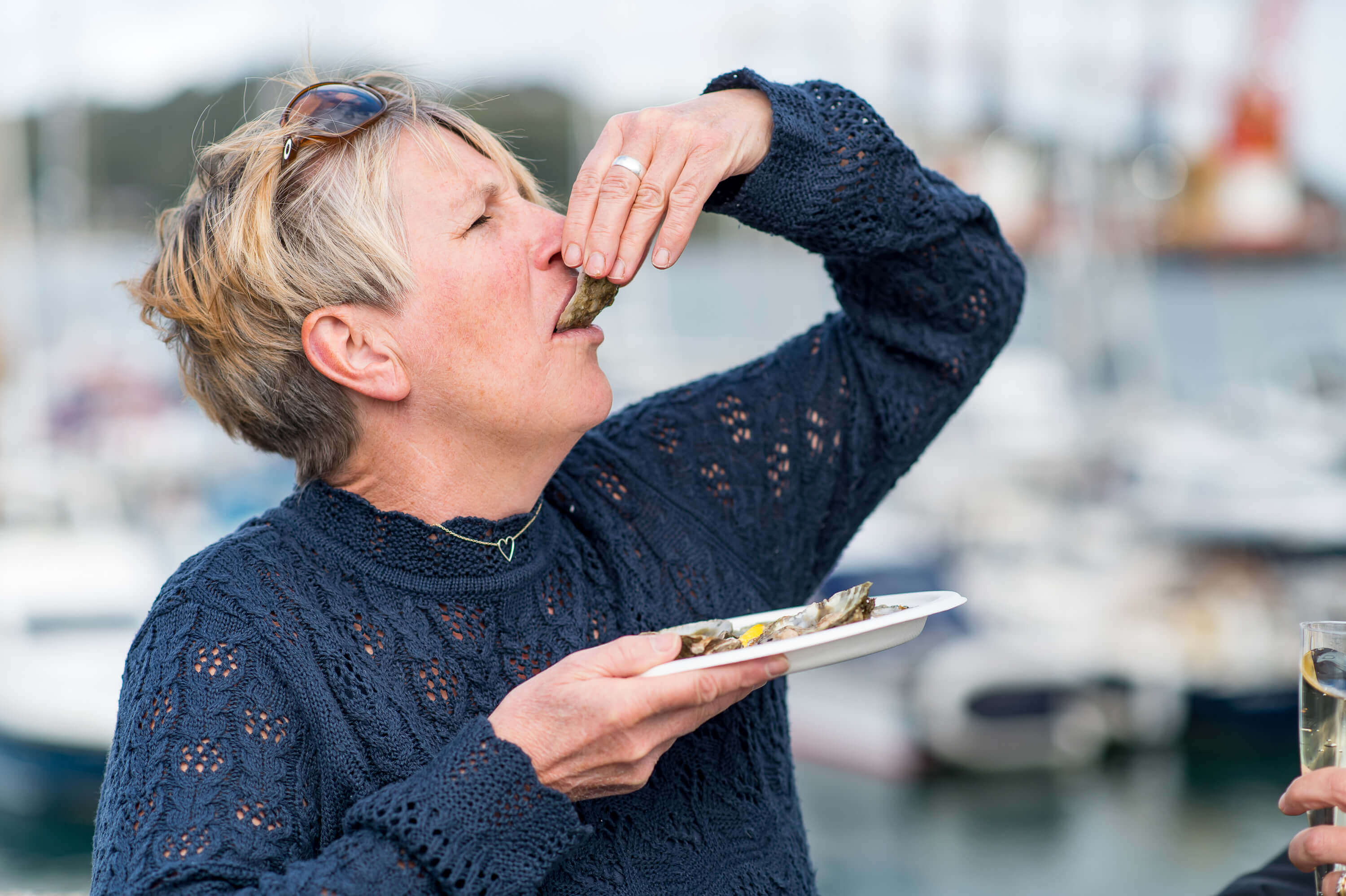 A visitor tasting a native oyster by the harbour in Falmouth