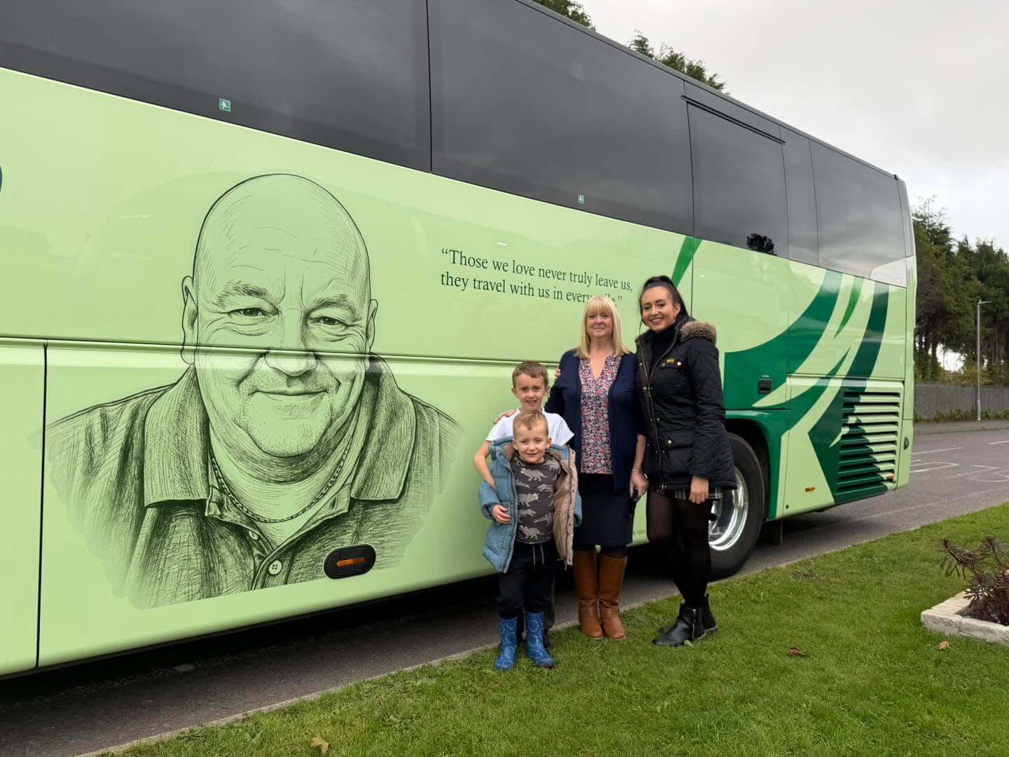 Jonathan Ede's family beside the memorial coach