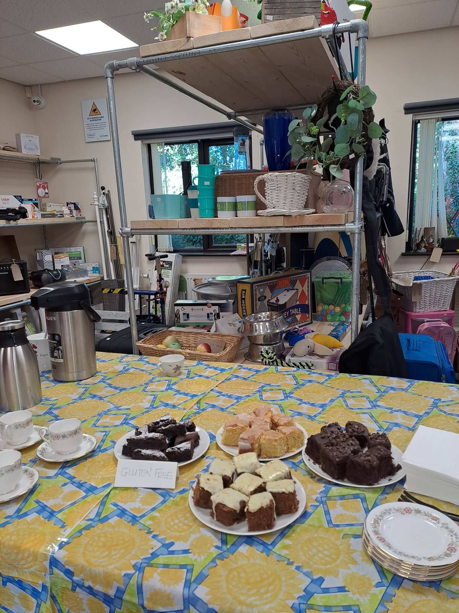 Cakes and tea set out inside the Kernow Reuse Shop at Connon Bridge