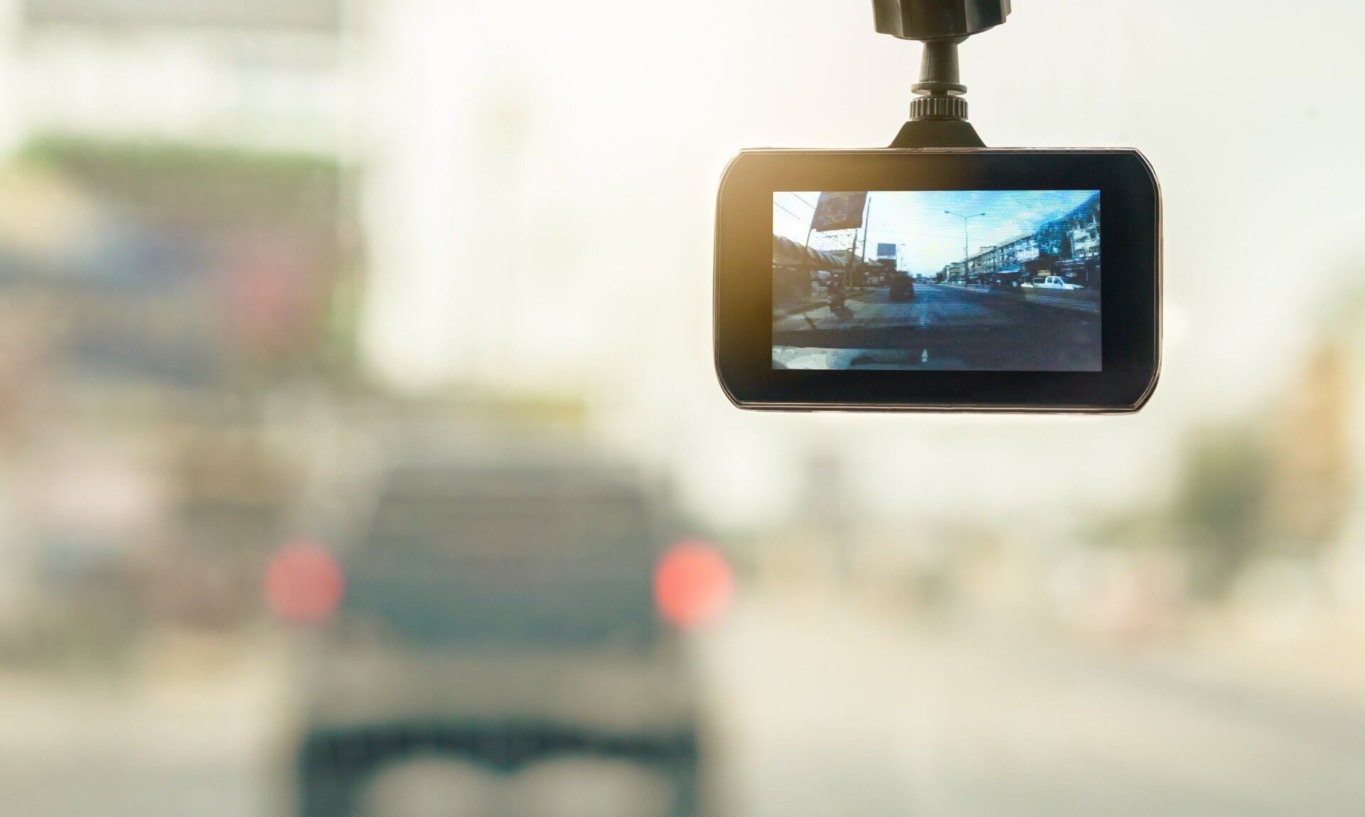 Dash camera mounted on a car windscreen with traffic ahead