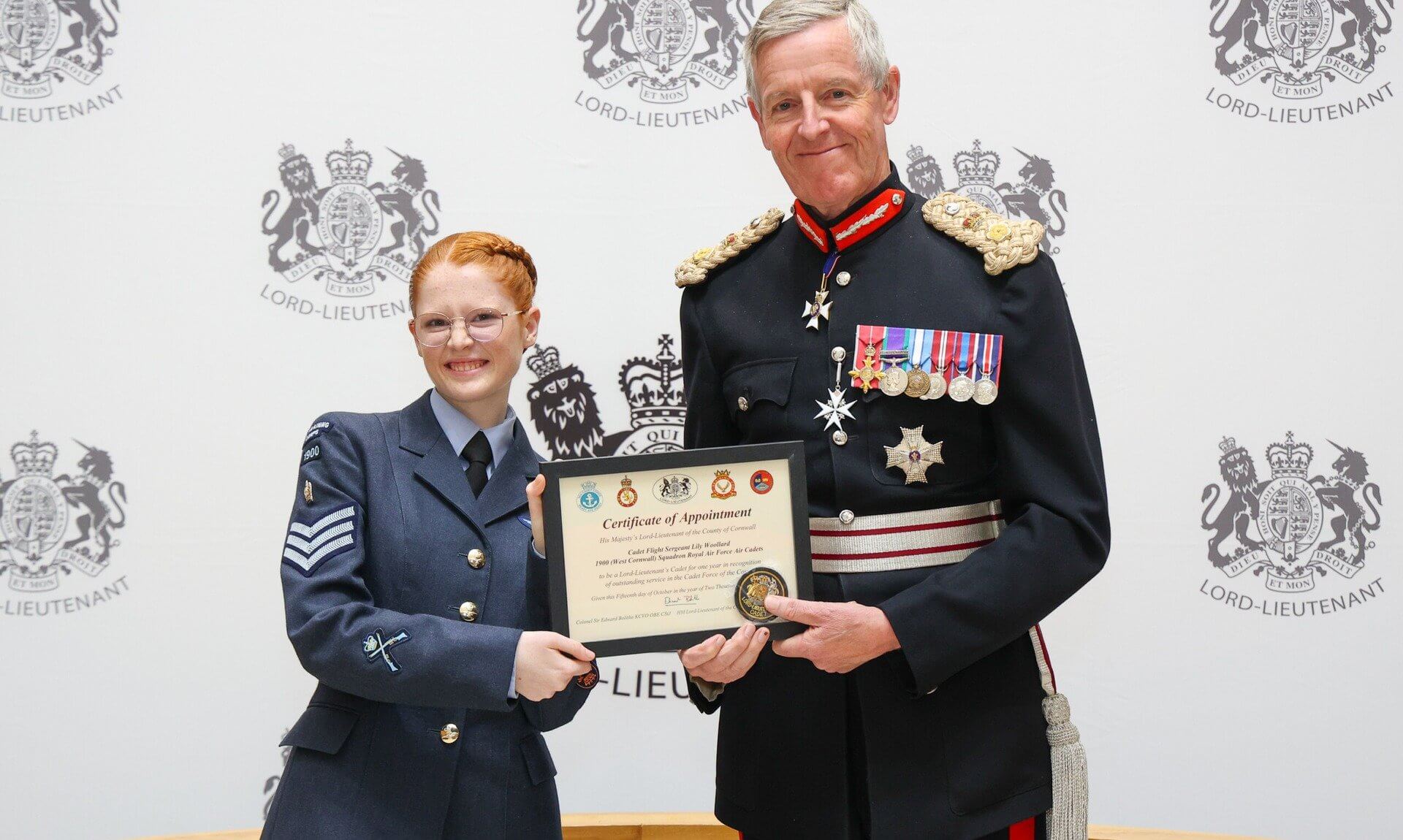 Cadet Flight Sergeant Lily Woollard receiving her certificate from Colonel Sir Edward Bolitho