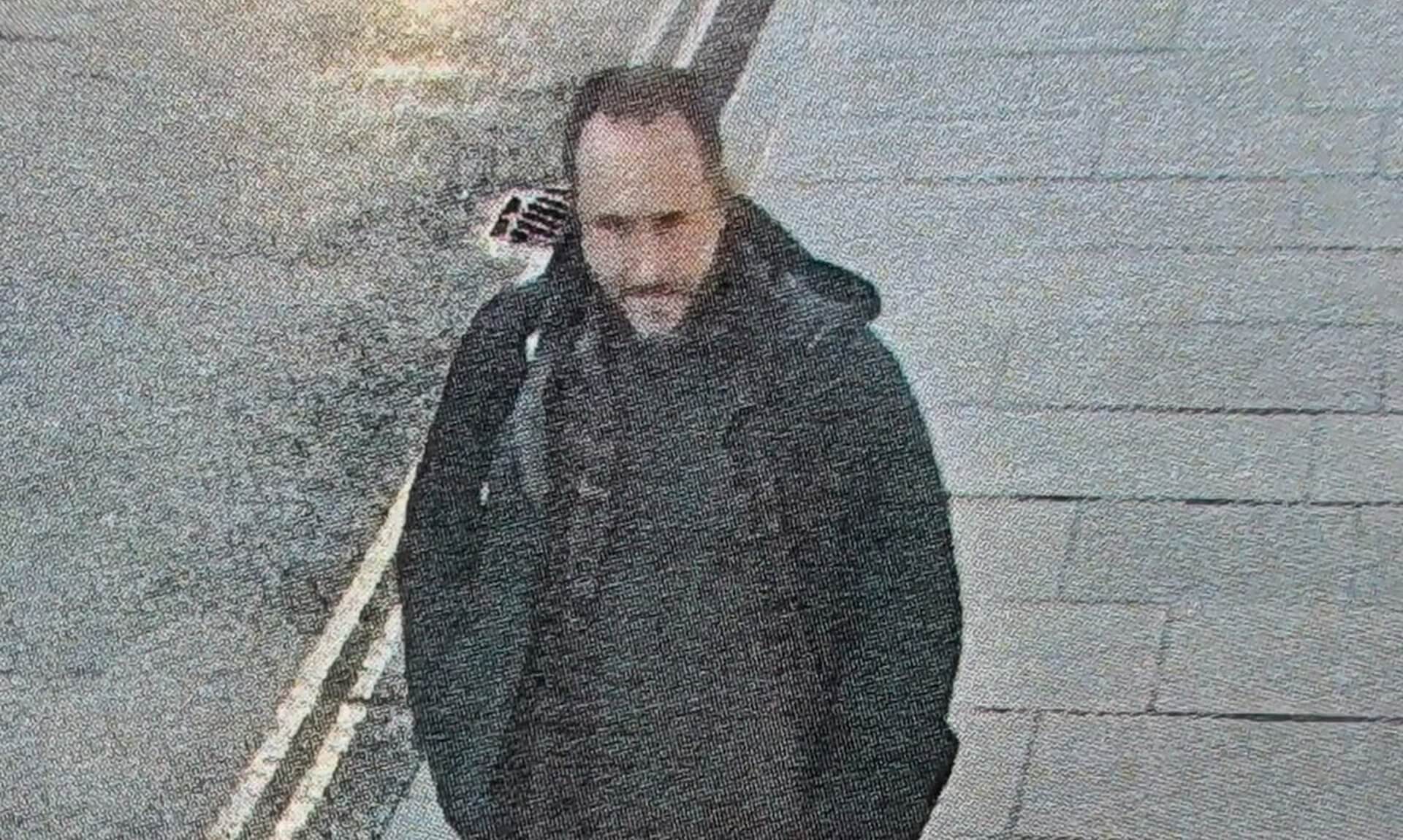 Image issued in the appeal to find Matthew, missing in North Cornwall, showing a man in a black coat walking along a pavement