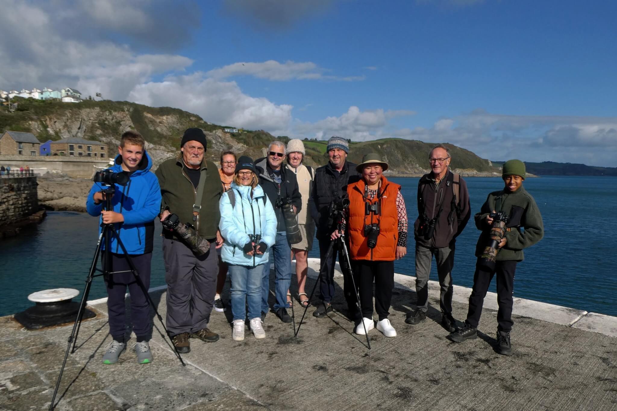 Birdwatching group with cameras and tripods on Mevagissey Harbour