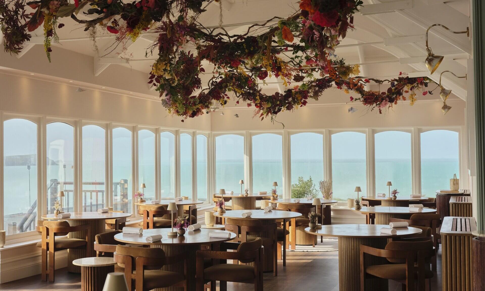 Ugly Butterfly restaurant dining room decorated for Christmas with sea views over Fistral
