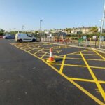 Newly resurfaced Newquay Railway Station car park with yellow hatched disabled bays