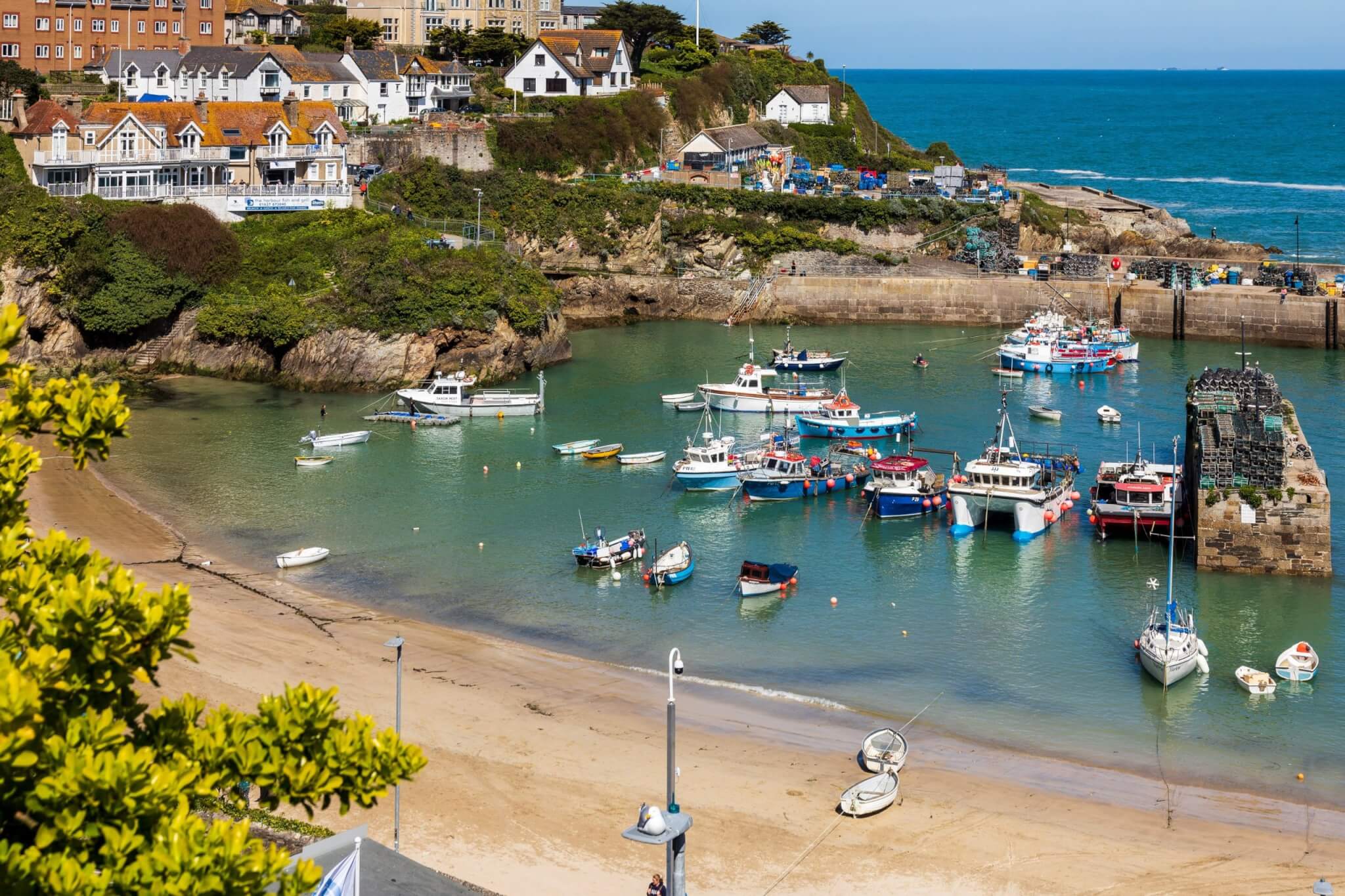 Fishing boats moored in Newquay harbour on a sunny day
