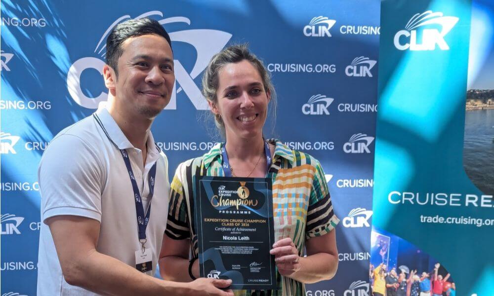 Nicola Leith holding her Expedition Cruise Champion certificate