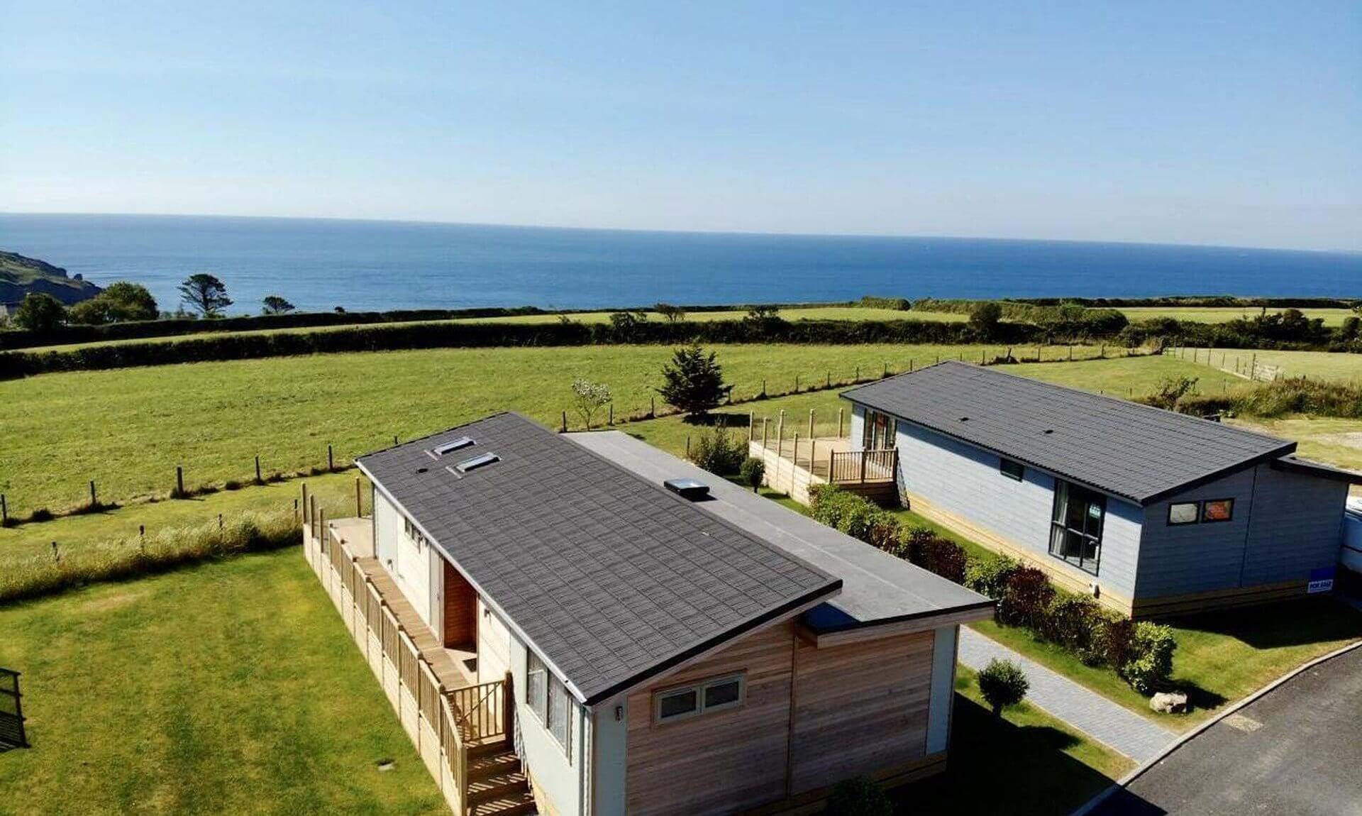 Holiday lodges at Seaview Holiday Park near Gorran Haven with the sea beyond