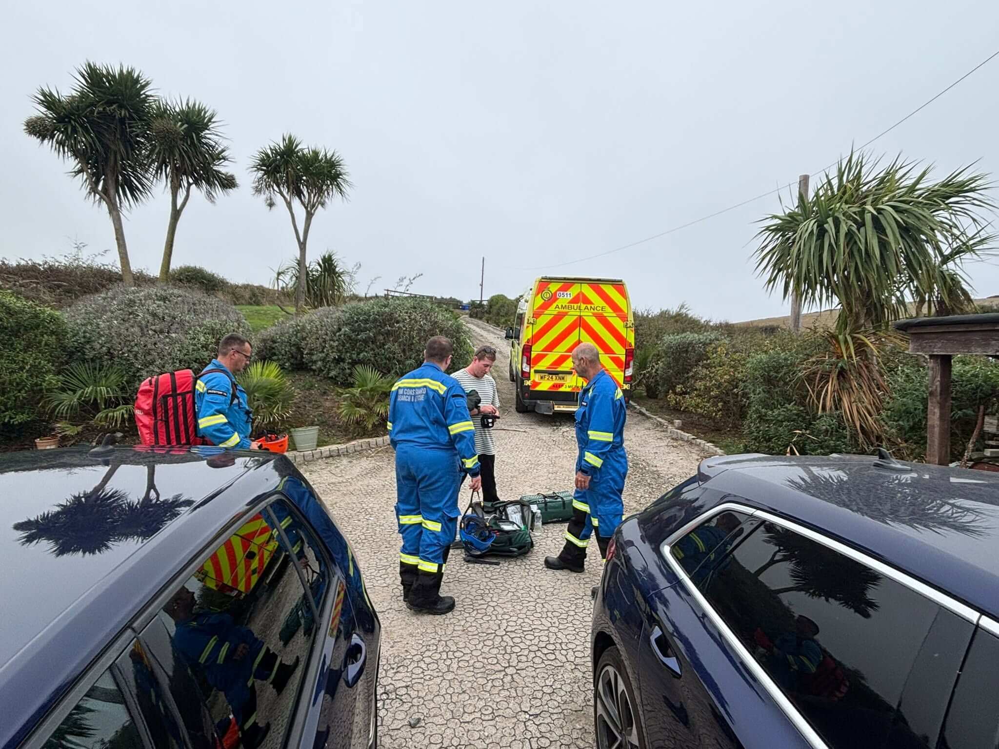 HM Coastguard Padstow team members with a casualty and an ambulance at Hawkers Cove