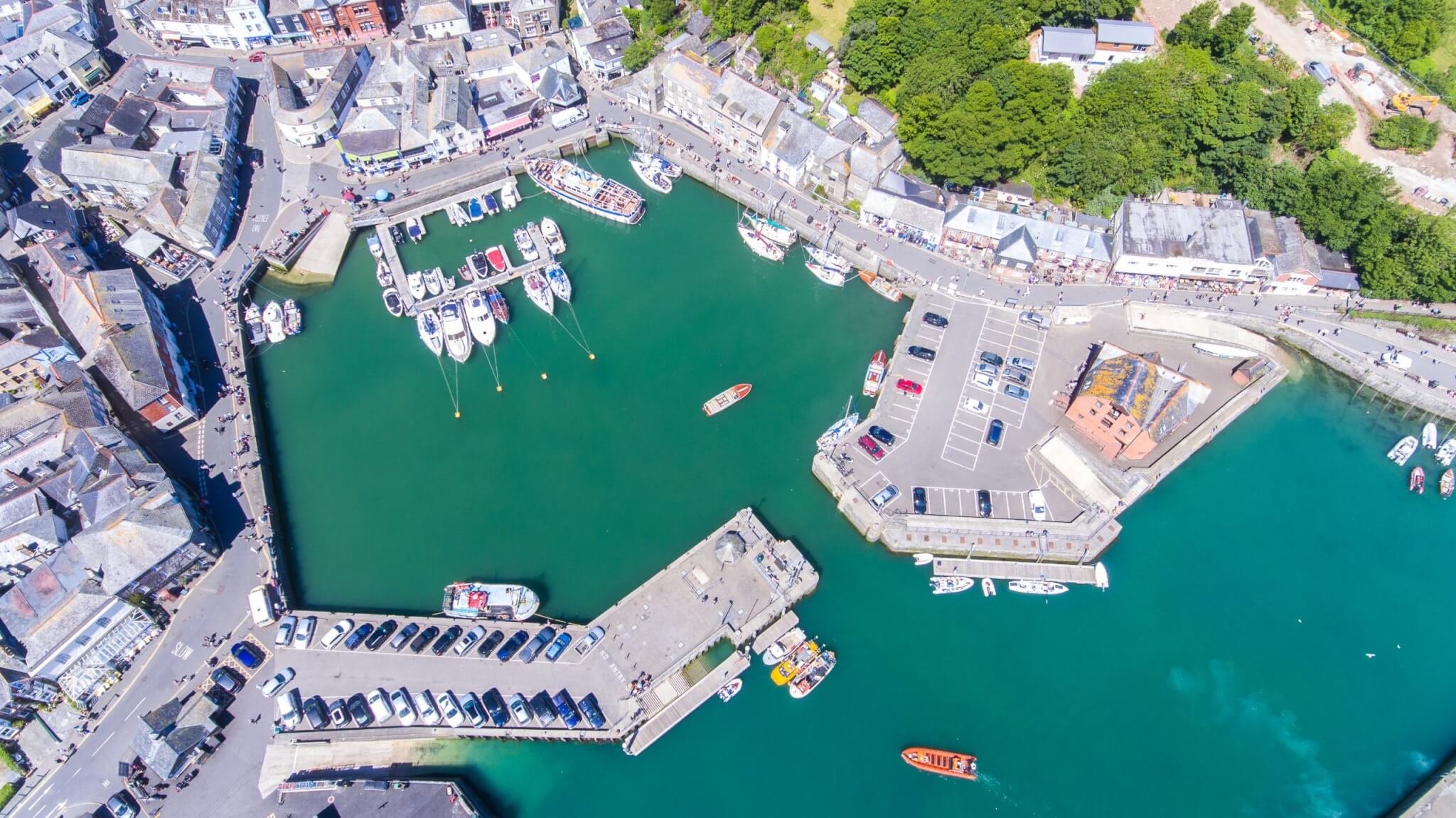 Aerial view of Padstow harbour with boats and quayside shops