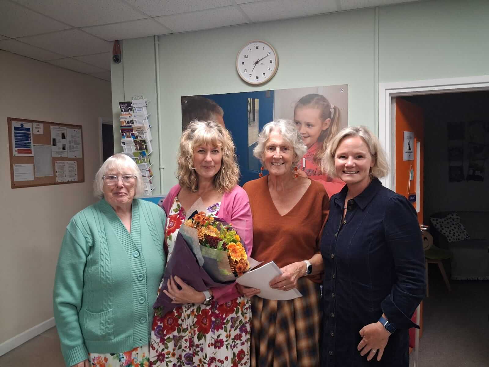 Penhaligon's Friends Chief Executive Julie Parker holding flowers with guests at the charity's AGM