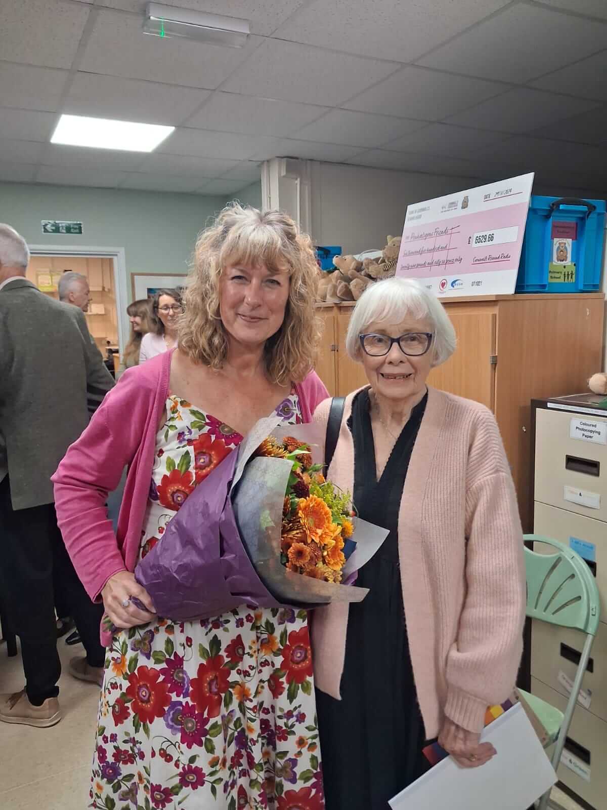 Julie Parker holding a bouquet at the Penhaligon's Friends celebration