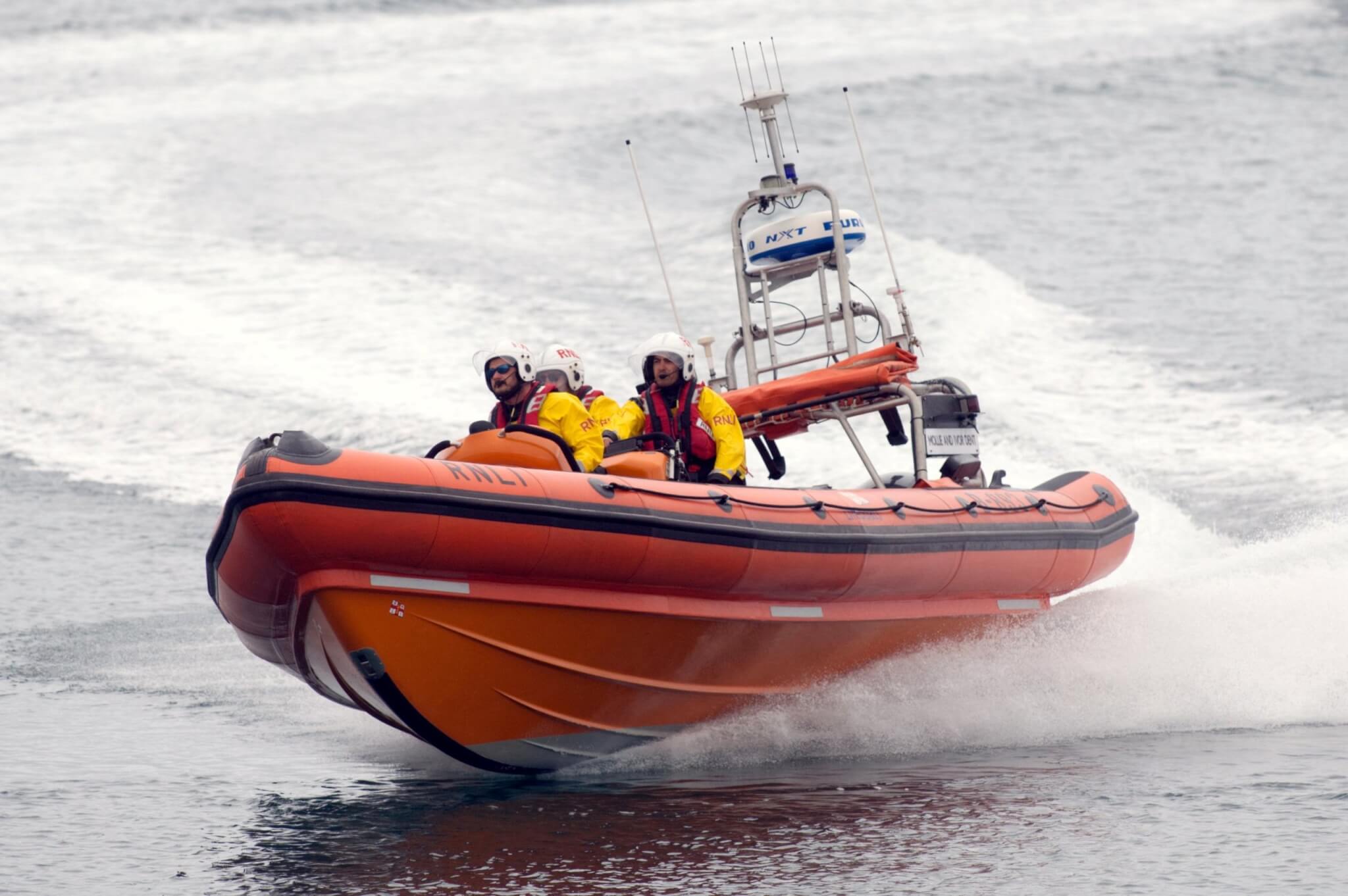 Penlee inshore lifeboat Mollie & Ivor Dent at speed with three crew aboard