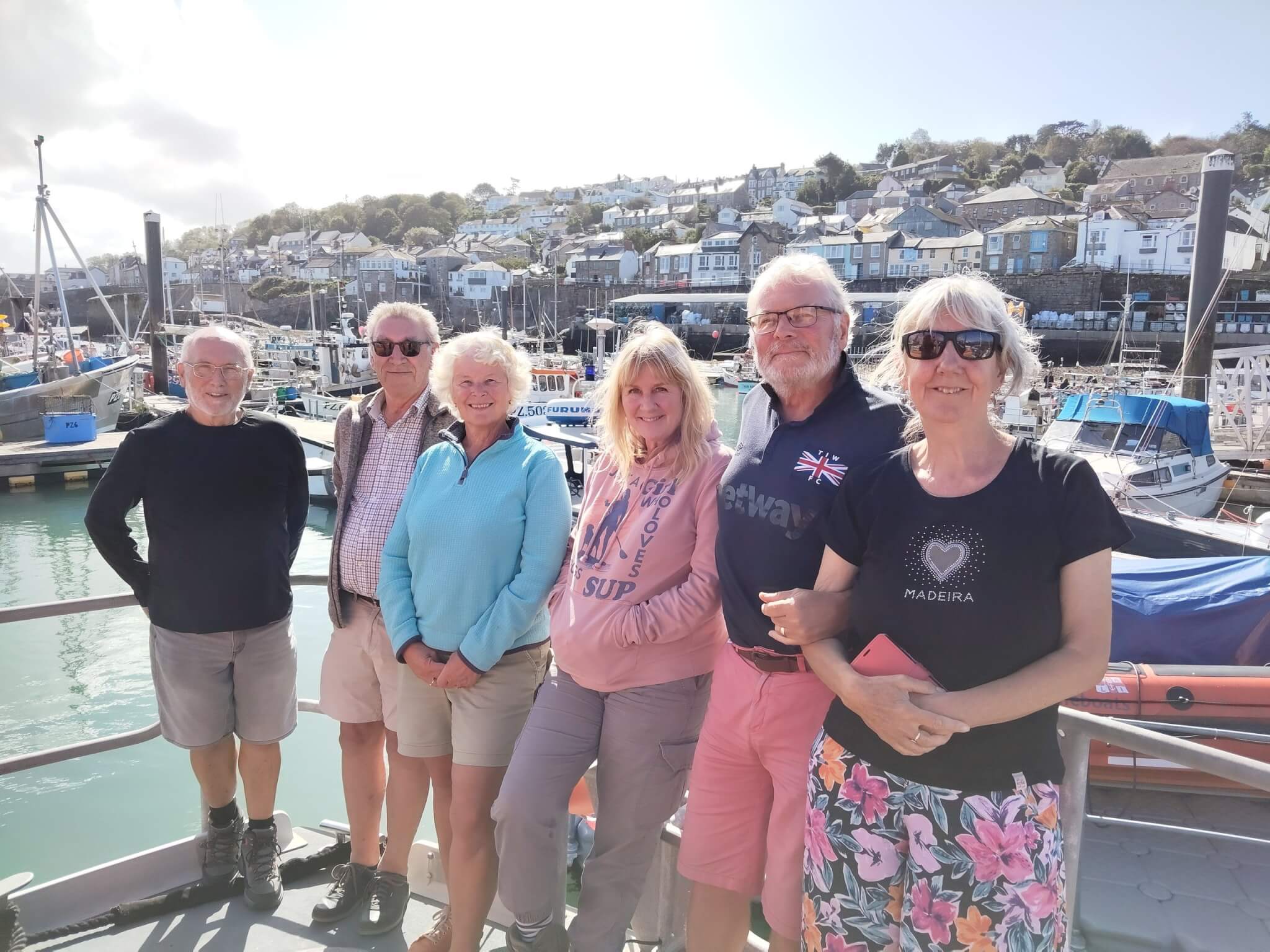 Guests on the VIP visit at Penlee Lifeboat Station with Newlyn harbour behind