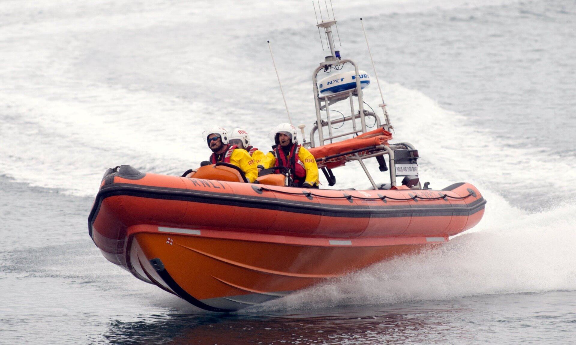 Penlee inshore lifeboat Mollie & Ivor Dent at speed with three crew aboard