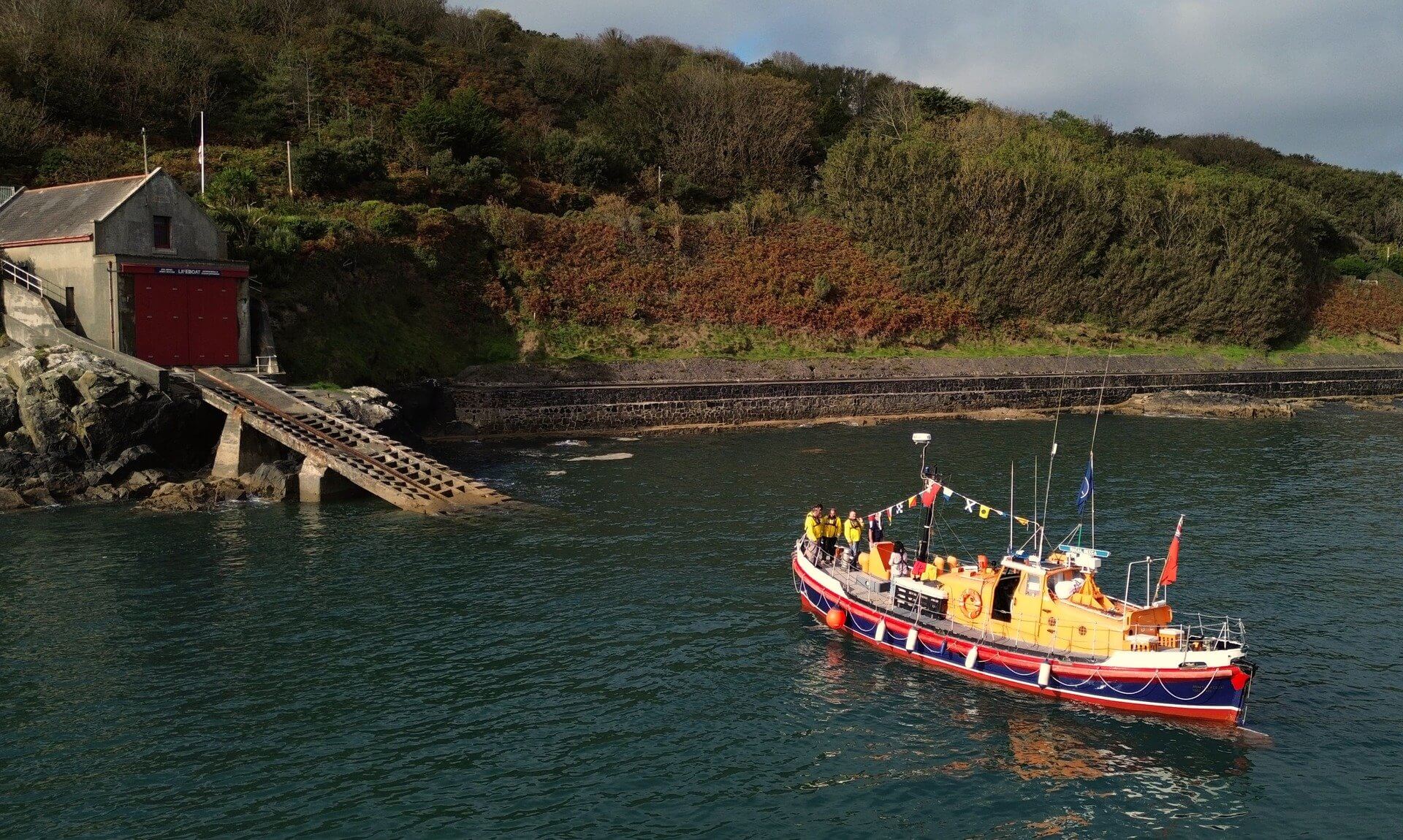 Former RNLI Watson class lifeboat A.M.T. off the old Penlee Point boathouse and slipway