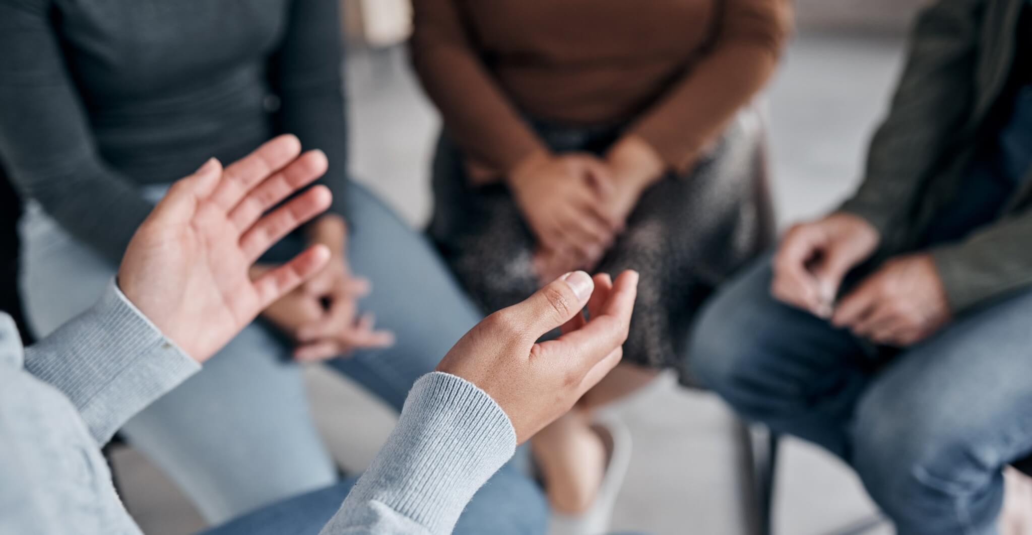 People sitting in a circle talking at a support group