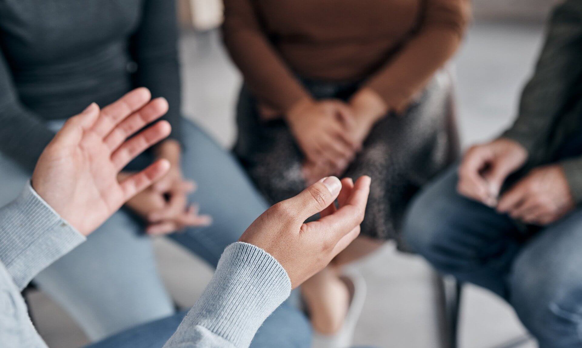 People sitting in a circle talking at a support group