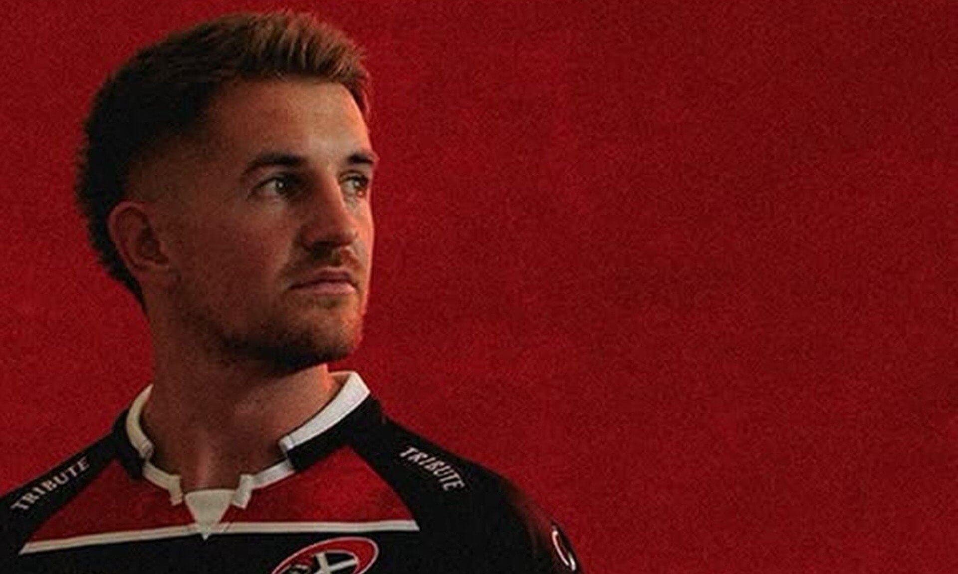 Cornish Pirates player in the club's red and black hooped shirt