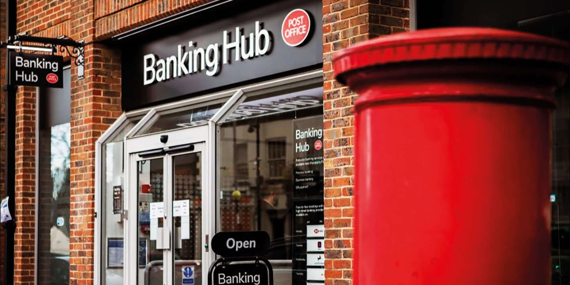 Post Office Banking Hub shopfront with a red postbox outside