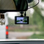 Dashcam mounted on a car windscreen in the rain