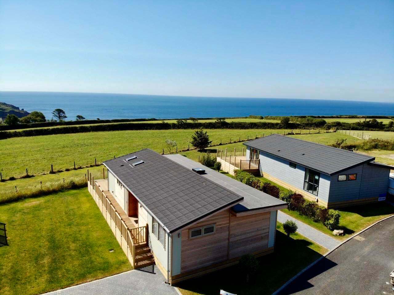 Holiday lodges at Seaview Holiday Park near Gorran Haven with the sea beyond