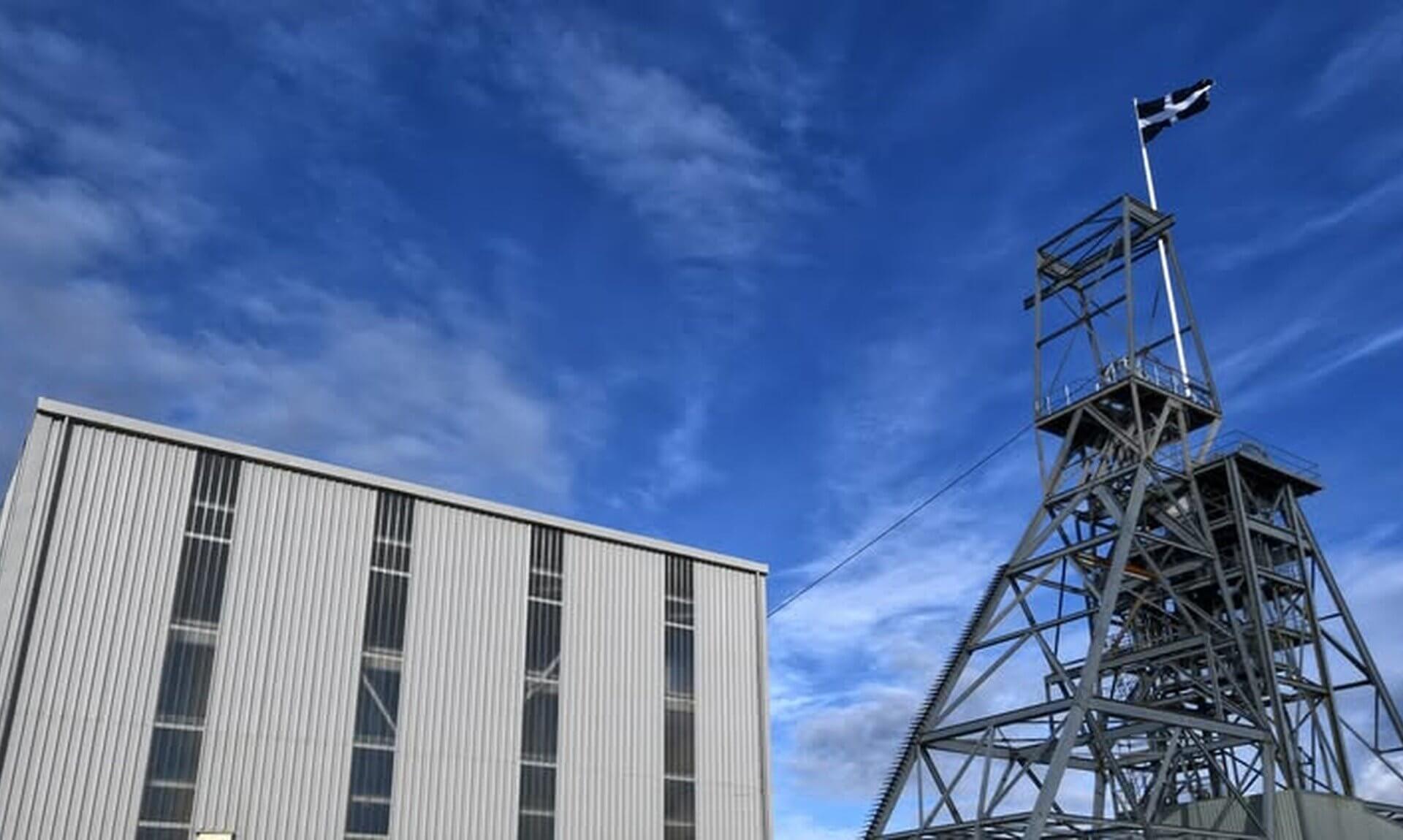 South Crofty mine headframe flying the Cornish flag beside a mine building