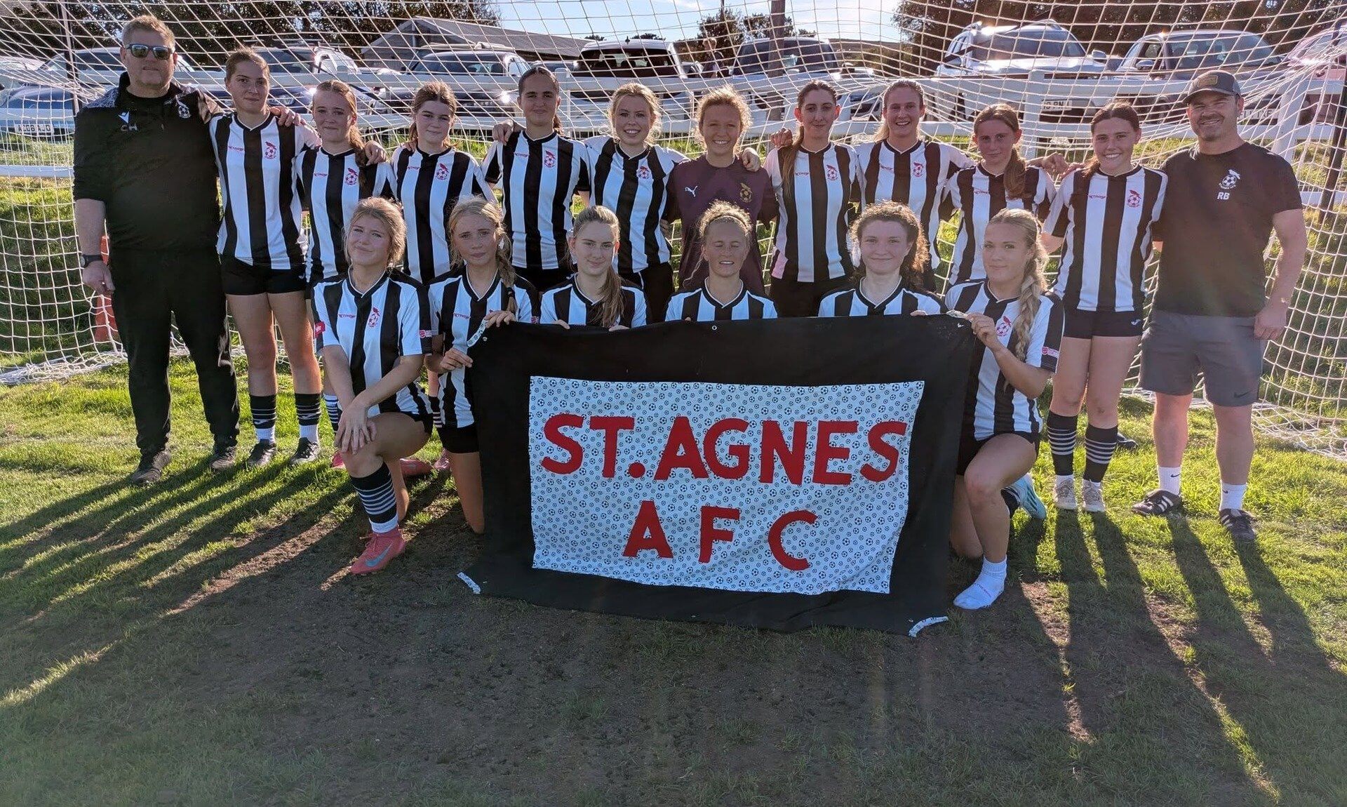 St Agnes AFC Ladies team photo with a St Agnes AFC banner