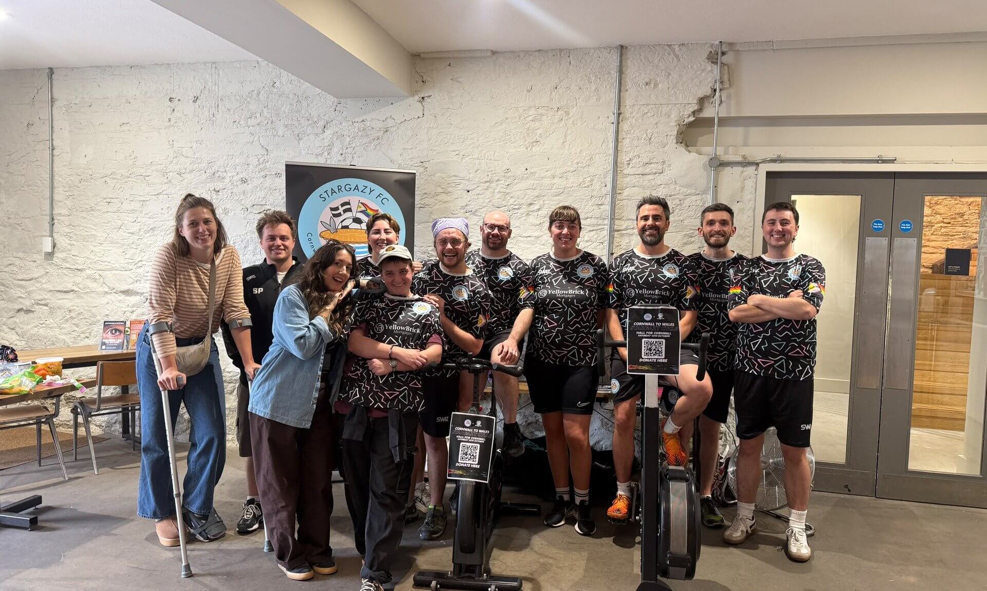 Stargazy FC players and supporters gathered around two exercise bikes at Hall for Cornwall