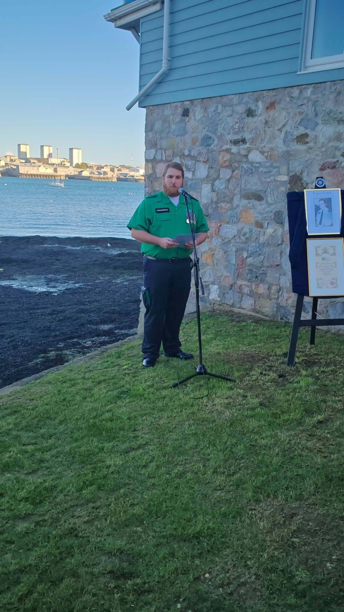 A St John Ambulance paramedic delivering a tribute to Roger Cook on the Torpoint waterfront