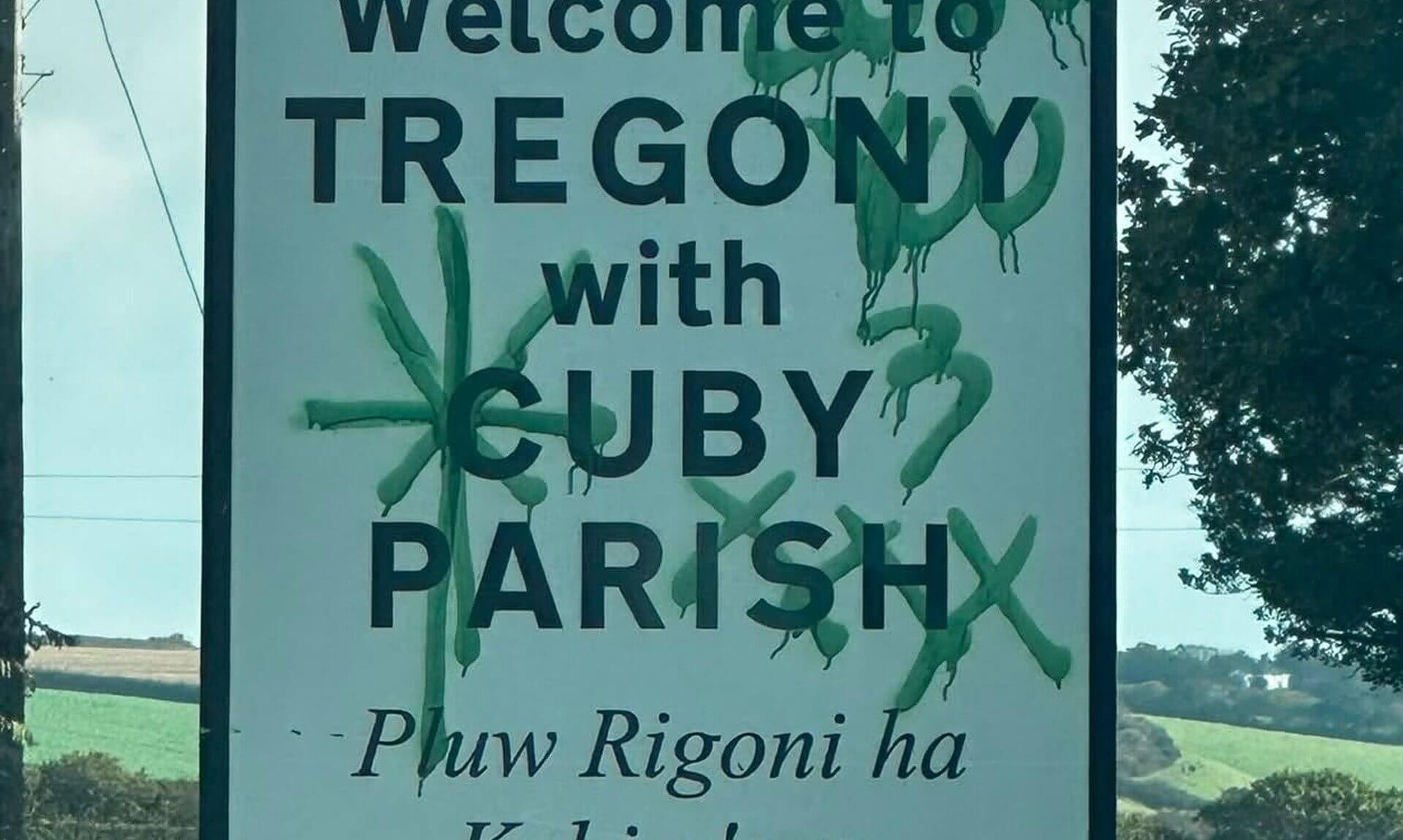 Green graffiti sprayed across the Welcome to Tregony with Cuby Parish road sign