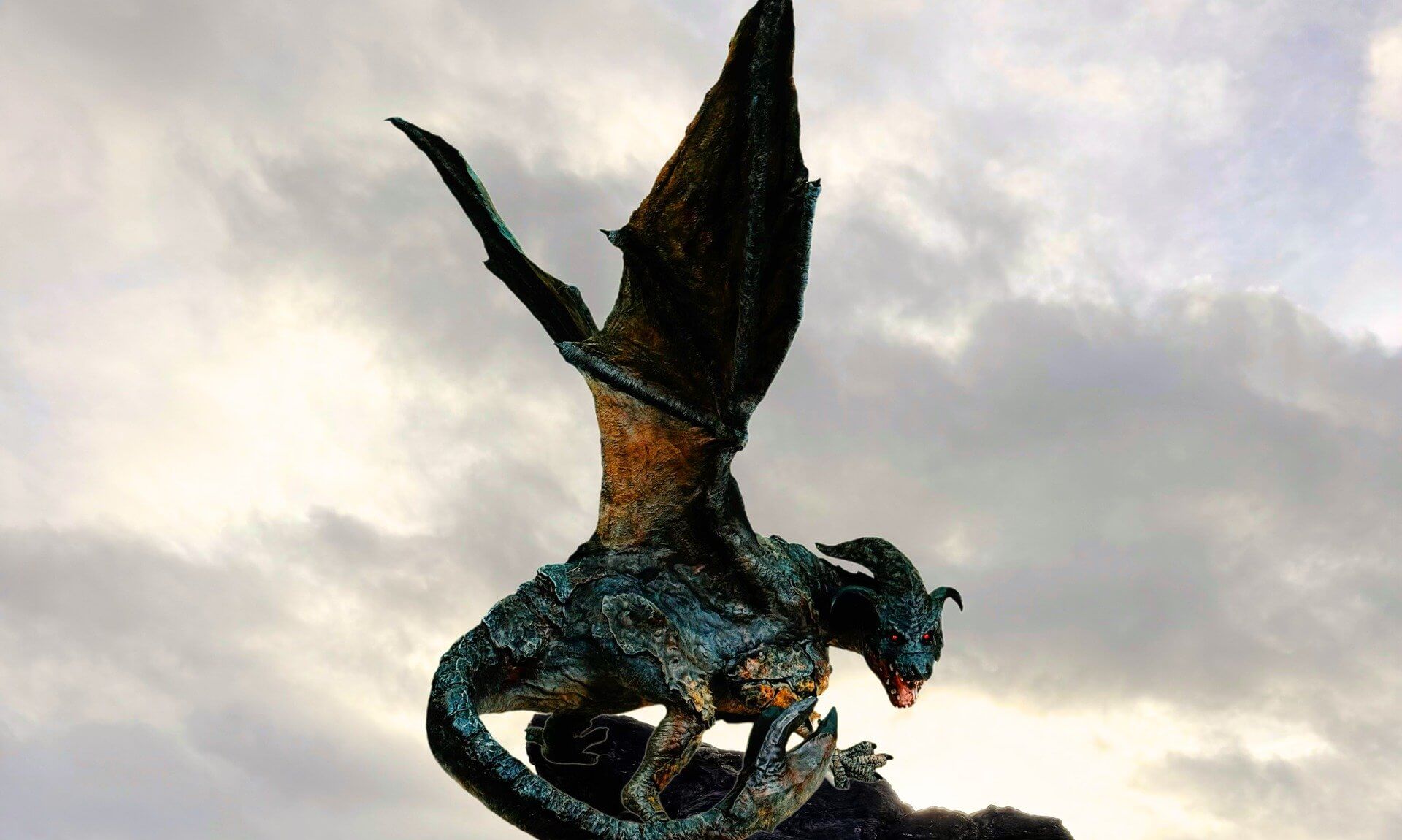Dragon of Porthtowan sculpture perched on rocks