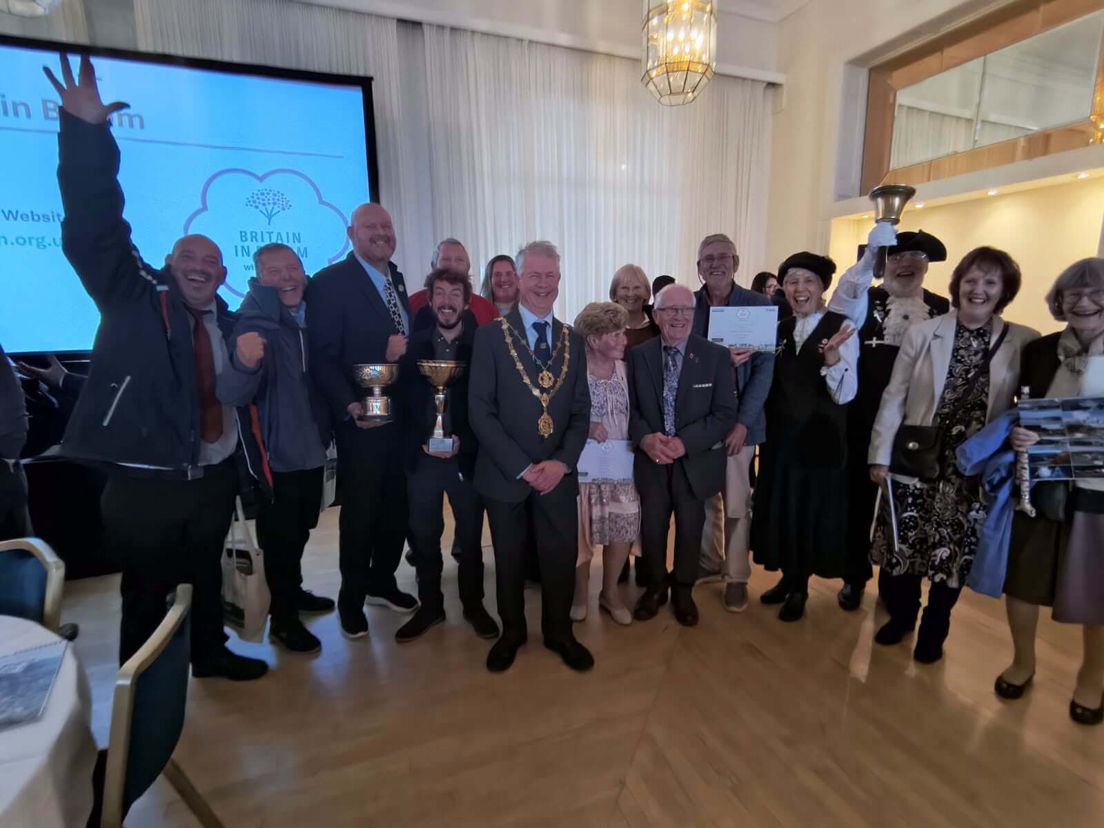 Truro's in Bloom team celebrating with trophies and certificates at the awards
