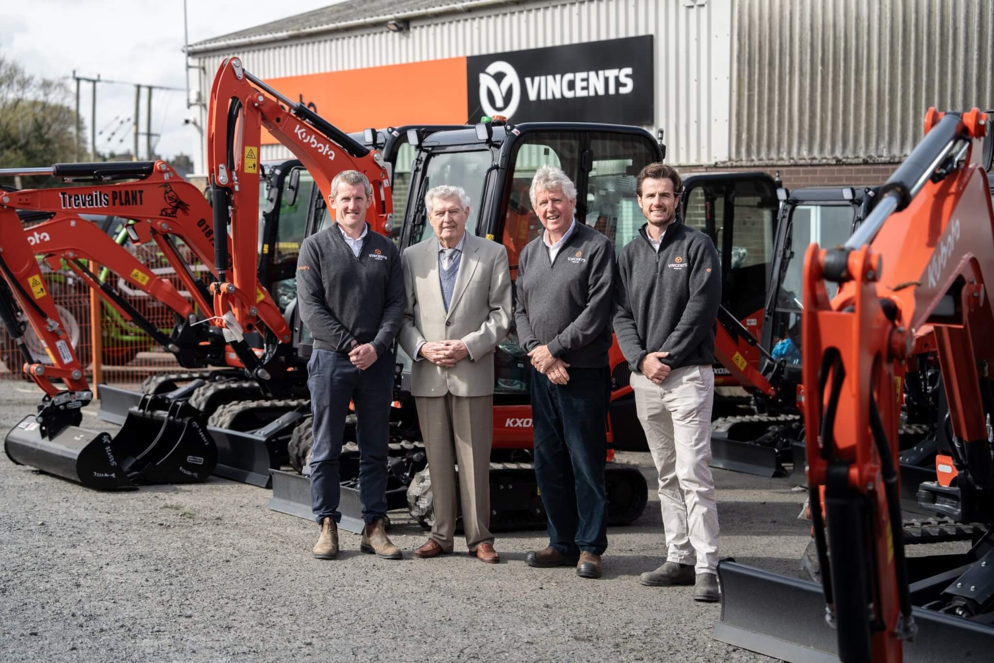 Vincent family members with Kubota mini diggers outside the Vincents depot
