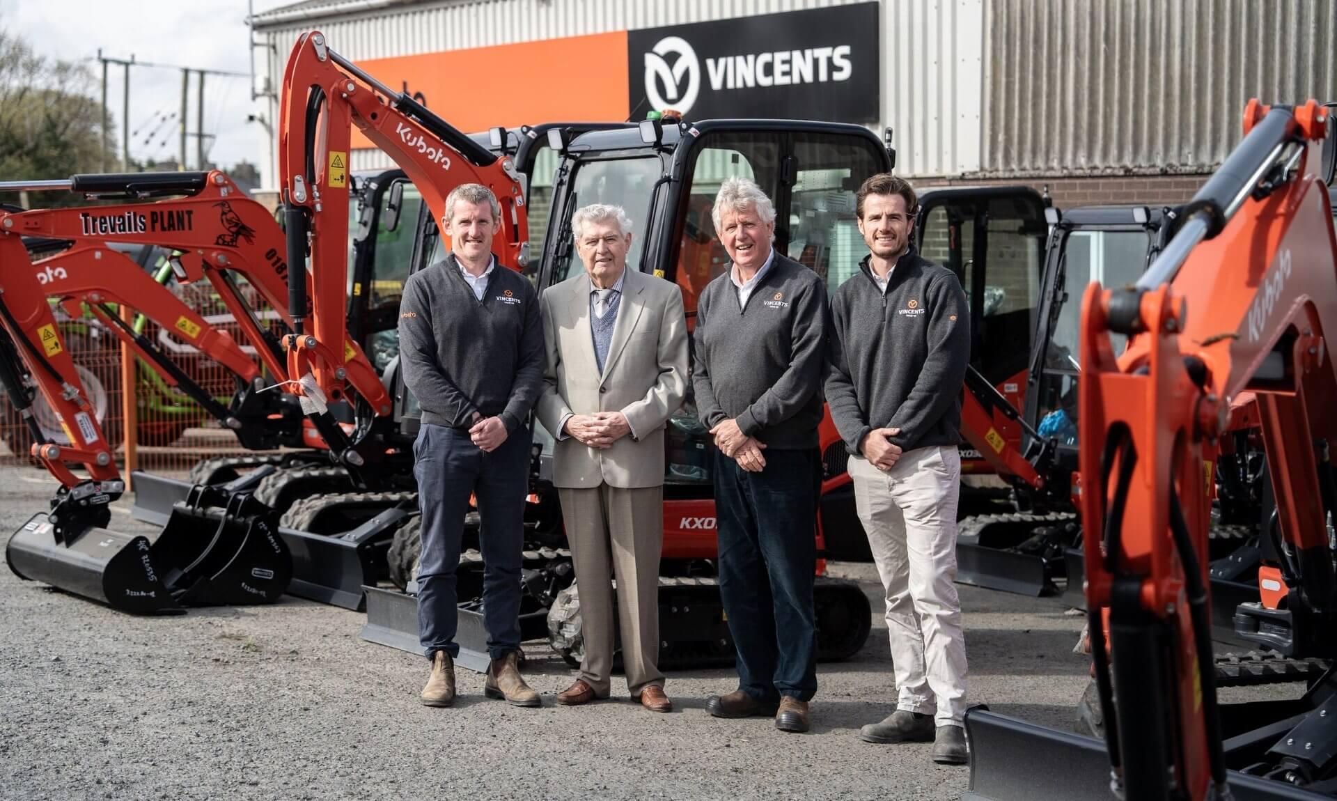 Vincent family members with Kubota mini diggers outside the Vincents depot