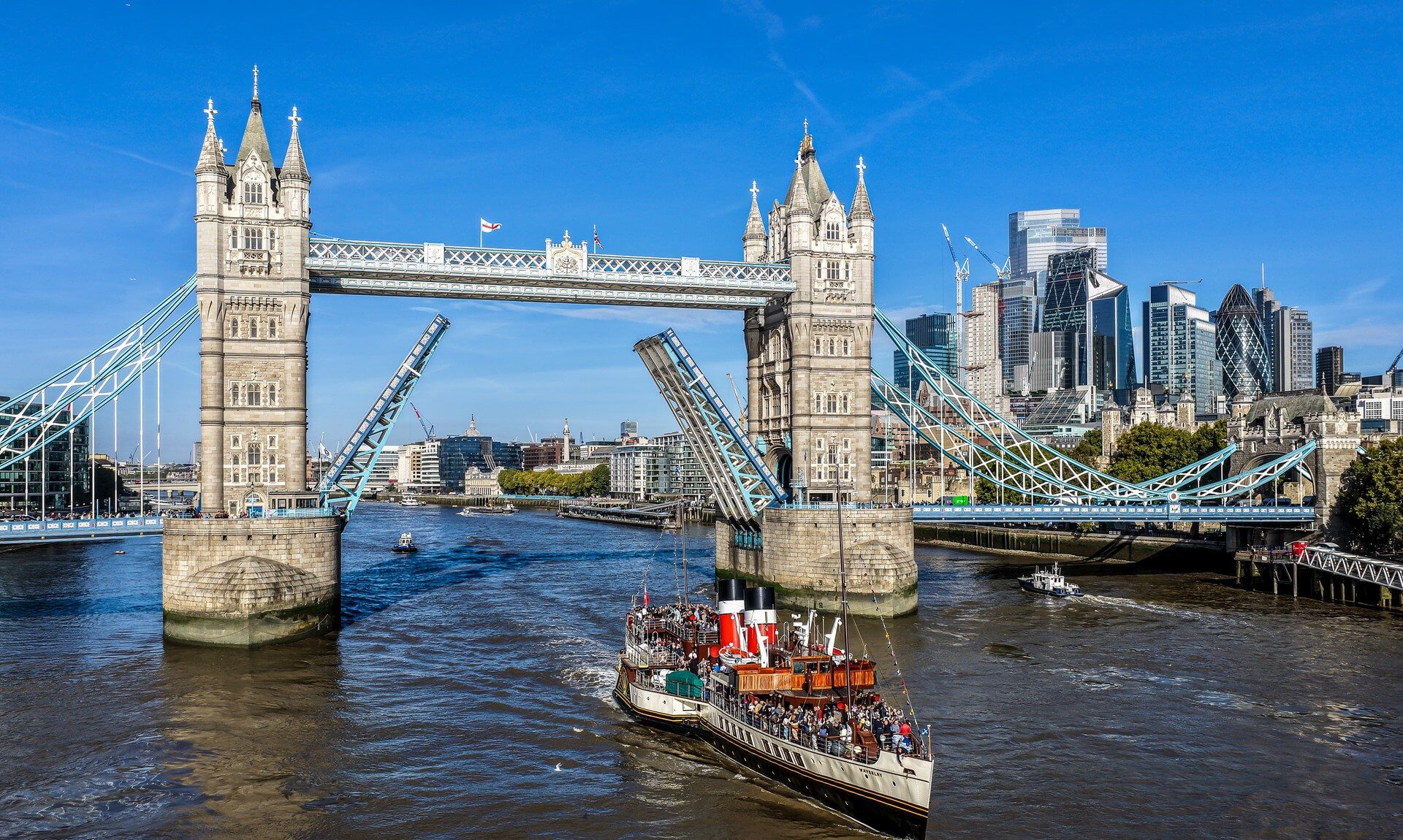 Paddle Steamer Waverley passing through the raised Tower Bridge in London